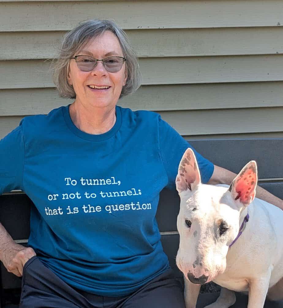 woman wearing a blue shirts with white bull terrier